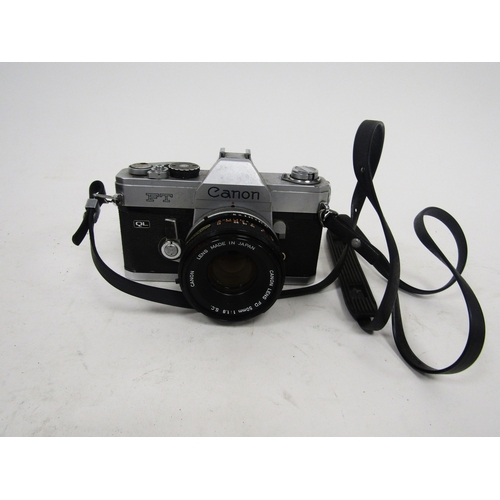 154 - Canon reflex FTQL camera, no. 125836 together with a Canon Hanimex tele-lens no.H67689, with two ins... 