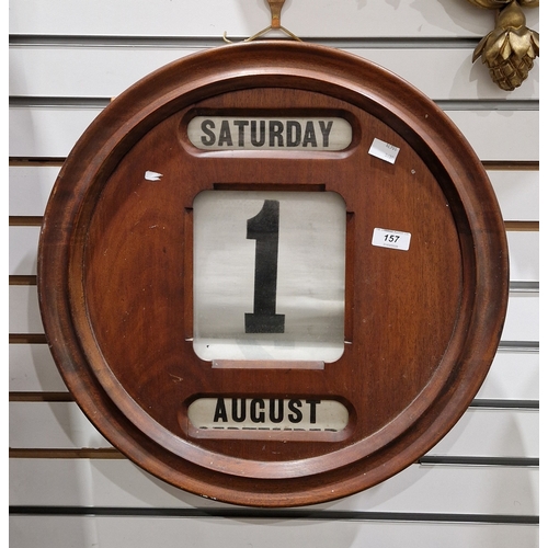 157 - Edwardian mahogany circular wall perpetual calendar, the three apertures holding canvas days, dates ... 