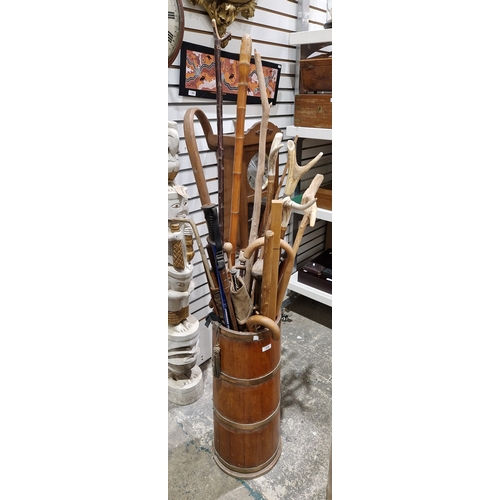 158 - Late 19th/early 20th century mahogany and brass-bound coopered stickstand, 66cm high containing a co... 
