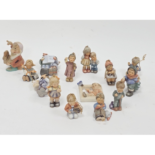 28 - Collection of Goebel Studio Hummel Christmas decorations, modelled as groups of children, suspended ... 