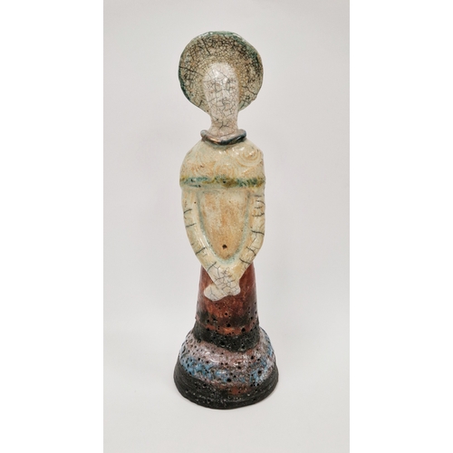 4 - Shelagh Spear raku figure of a standing woman, with headdress and arms crossed, on a domed base, vol... 