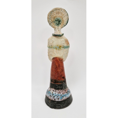 4 - Shelagh Spear raku figure of a standing woman, with headdress and arms crossed, on a domed base, vol... 