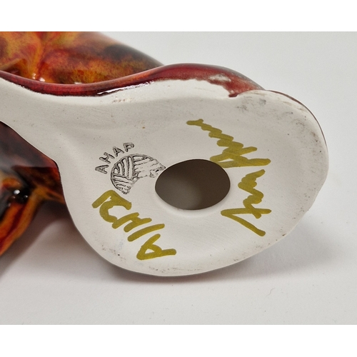 76 - Model of a Staffy dog by Anita Harris, 11cm high and a fox, recumbant, both signed in gilding, print... 