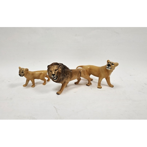 84 - Beswick pottery models of a lion, lioness and cub, printed marks, 22cm long (3)
