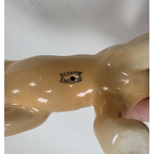 84 - Beswick pottery models of a lion, lioness and cub, printed marks, 22cm long (3)