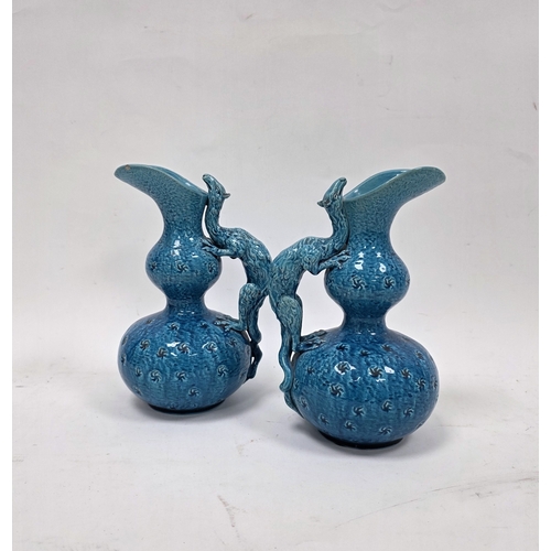 86 - Pair of Burmantofts turquoise ground dragon moulded double-gourd shaped jugs, late 19th century, imp... 