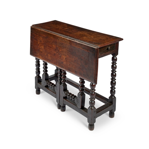 2 - A 17th century oak single flap drop flap table The rectangular hinged top above a drawer to one end,... 