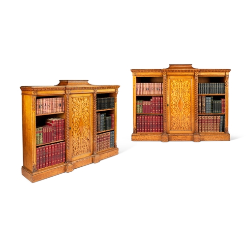 245 - A pair of early Victorian Jacobethan style carved oak low cabinet bookcases  In the manner of R... 