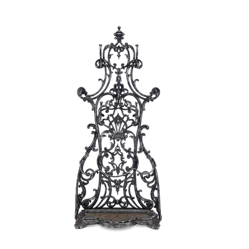 247 - A Victorian cast iron hall stand  The pierced scrolling back with twelve hooks, on a shaped pli... 