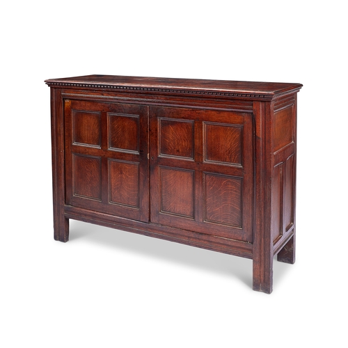 249 - A late Victorian Arts & Crafts oak side cabinet in the manner of Philip Webb The rectangular top... 