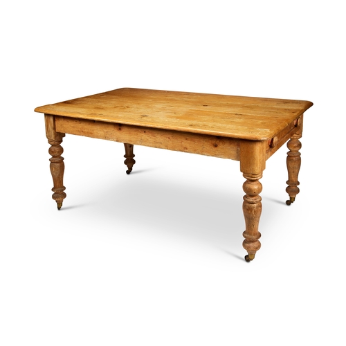 253 - A Victorian pine kitchen table  The rounded rectangular top above a drawer at one end, on ... 