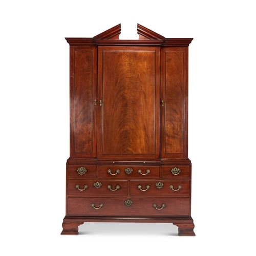 74 - A George III mahogany estate cabinet The cavetto moulded broken arch pediment above a central panell... 