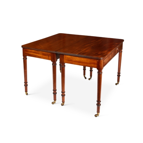 107 - A late George III style mahogany dining table  With leaf, the rounded rectangular top with reeded ed... 