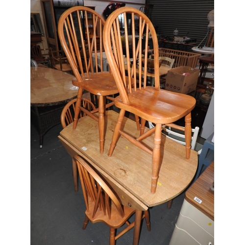 378 - Drop flap kitchen table and 4x Pine stick back chairs