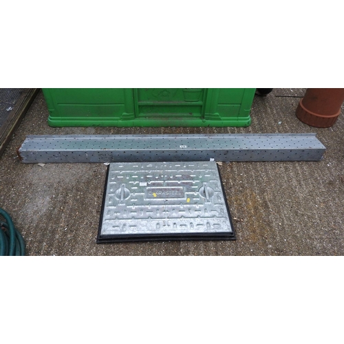110 - 2x lintels and a manhole cover