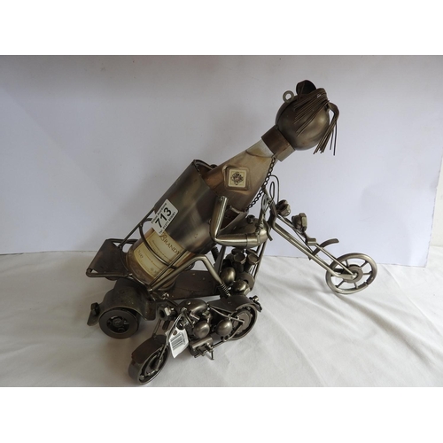 713 - Novelty motorcycle bottle holder, other motor cycle ornament and a Brandy bottle