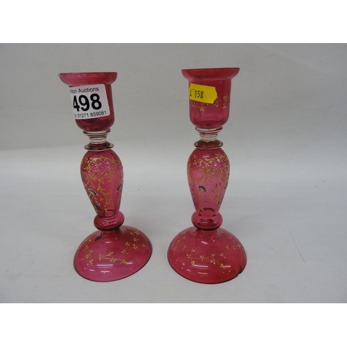 498 - Pair of decorated Cranberry glass candlesticks