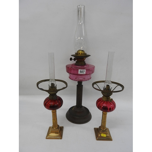 507 - 3x brass oil lamps with coloured glass reservoirs