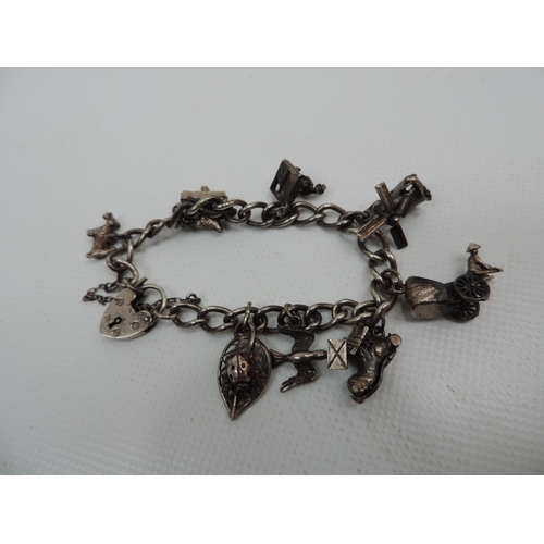 195 - Sterling Silver Charm Bracelet with 8x Charms - Some Articulated