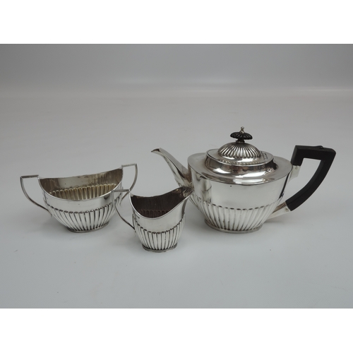 254 - An Edwardian Silver Tea Set - Teapot, Cream/Milk and Sugar with Part-Fluted Decoration, Scroll Handl... 