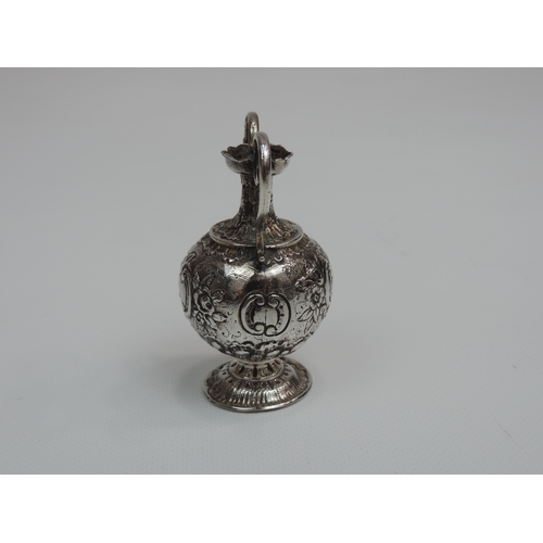 222 - A Miniature Silver Vase in the Classical Twin Handled Urn Style and Embossed with Ffoliage - It has ... 