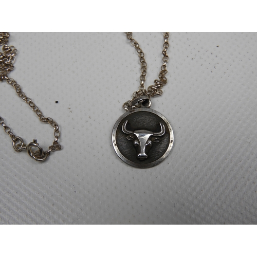 313 - A Silver and Enamel Photo Pendant, A Silver Taurus Bull Pendant with Chain, A Brass Compass, An Isle... 