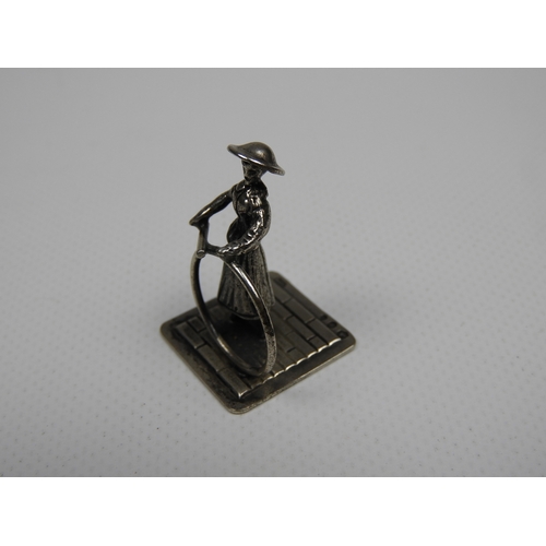 317 - Silver Miniature: A Dutch Silver Miniature of a Girl Playing with a Hoop and Stick - Hallmarked with... 