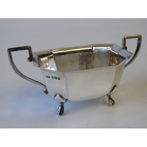 30 - An Art Deco Silver Tea Set - Teapot, Milk and Sugar, Canted Rectangular Form Standing on Four Lions ... 