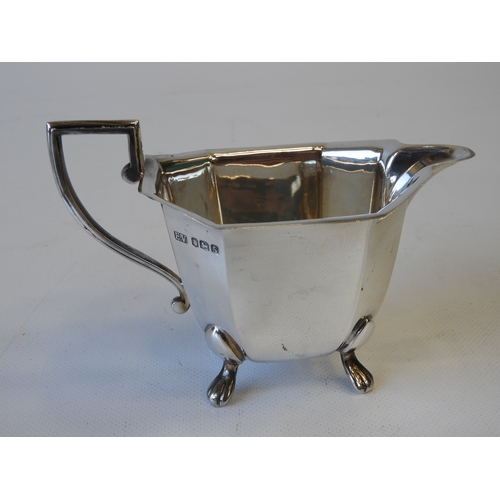 30 - An Art Deco Silver Tea Set - Teapot, Milk and Sugar, Canted Rectangular Form Standing on Four Lions ... 