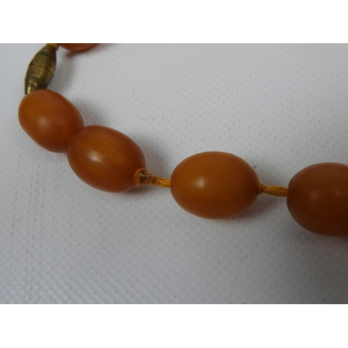 66 - Necklace - String of Amber Coloured Beads