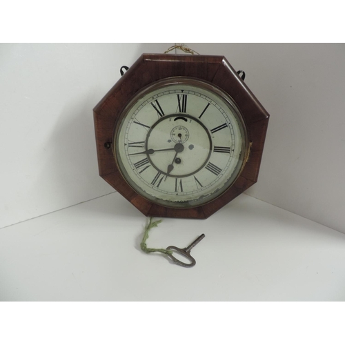 831 - Octagonal Two Dial Wood Cased Wall Clock - In Working Order