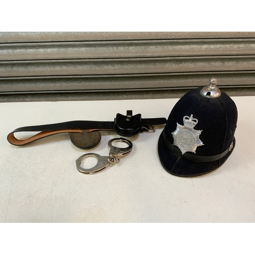 345 - Policeman’s Helmet, Belt and Handcuffs