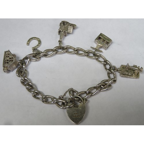 282 - Hallmarked silver charm bracelet, with heart form clasp and Five charms. Total Weight Approximately.... 