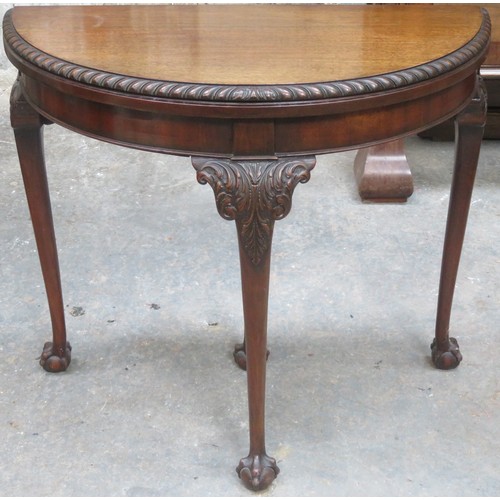 13 - Early 20th century piecrust edged mahogany fold over games table on ball and claw supports, with gre... 