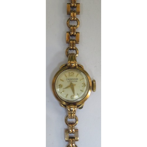 64 - 9ct gold Ladies J.W. Benson wrist watch on 9ct gold strap. Total weight. 11.1G