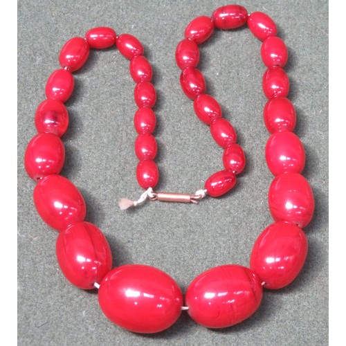 77 - Strand of graduated red amber beads. Weight Approximately. 53.9G
