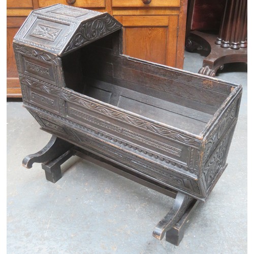 224 - RTV - 19th century heavily carved oak Jacobian style cradle, with hinged canopy, on stand. Approxima... 