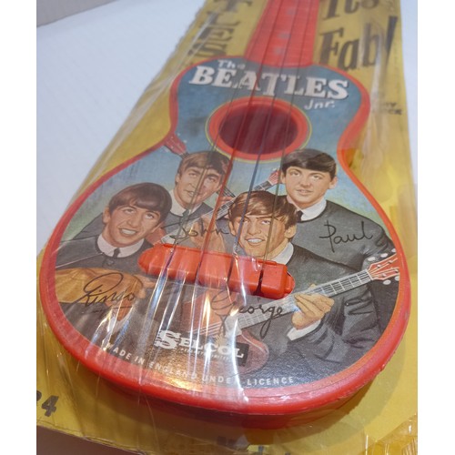 77 - The Beatles Jnr Guitar by Selcol sealed and attached to original backing card. UK 1964