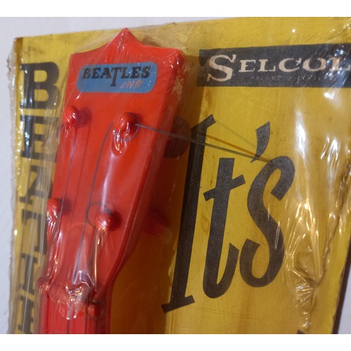 77 - The Beatles Jnr Guitar by Selcol sealed and attached to original backing card. UK 1964