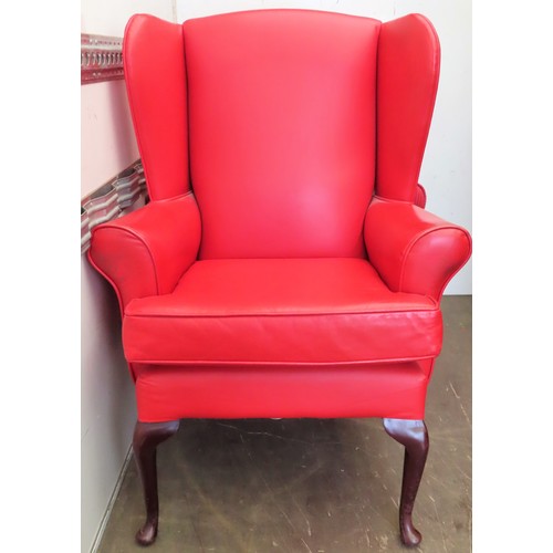 116 - 20th century red leather effect upholstered wing armchair. Approx. 114cms H x 74cms W x 70cms D