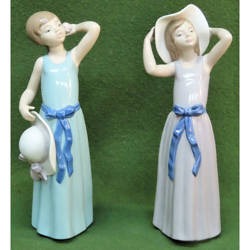 54 - Two Lladro glazed ceramic figures - Coiffure Girl with Straw Hat 5010 and Coy 5011