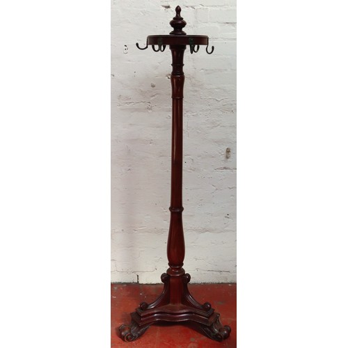 39 - Victorian mahogany freestanding coatstand, on tripod supports, with brass hanging handles. Approx. 1... 