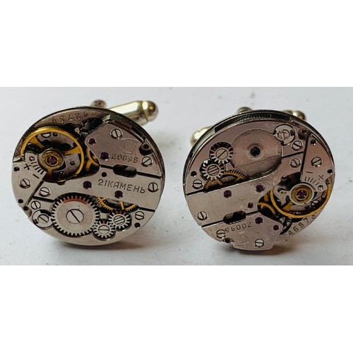 66 - SILVER COLOURED CUFFLINKS WITH WATCH MOVEMENT