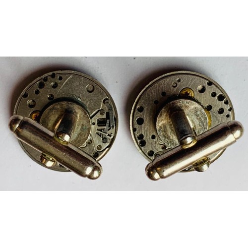 66 - SILVER COLOURED CUFFLINKS WITH WATCH MOVEMENT