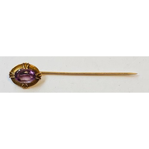 16 - RUBBED MARKED GOLD COLOURED PIN SET WITH AN AMETHYST, TOTAL WEIGHT APPROX 2g
