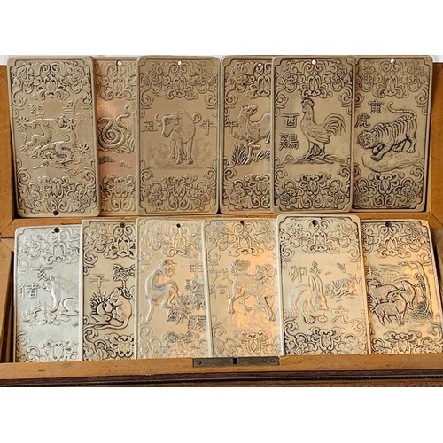 99 - TWELVE CHINESE VINTAGE SILVER COLOURED ZODIAC PLAQUES