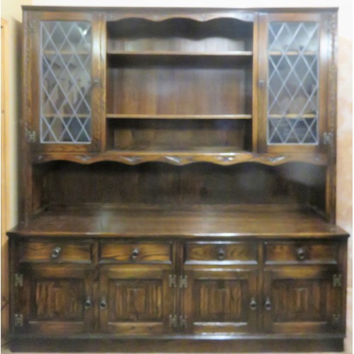 322 - Large 20th century carved and linen fold style kitchen dresser with leaded glass front. Approx. 194c... 