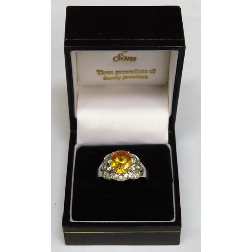 296 - Pretty 925 silver ladies dress ring, set with twenty small clear stones and large central Citrine co... 