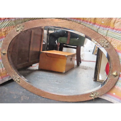 234 - Early 20th century hammered copper effect oval bevelled wall mirror. Approx. 60 x 85cm