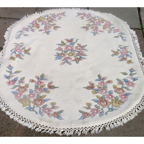 113 - 20th century floral decorated oval floor rug. Approx. 205cms L x 98cms W